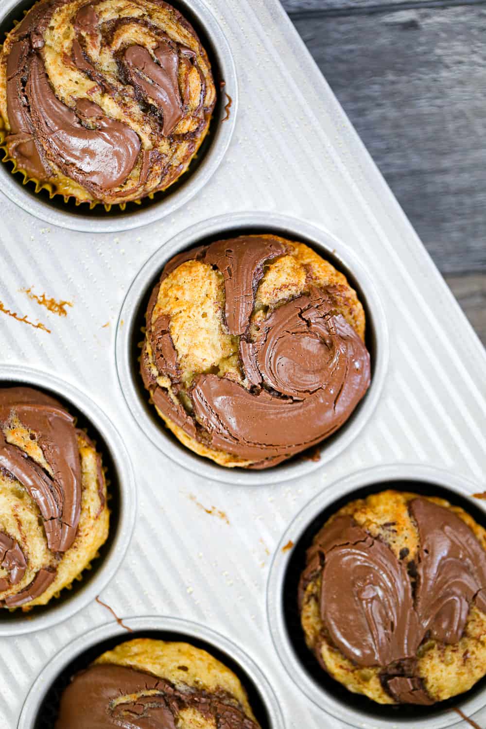 Banana Nutella Swirl Muffins in muffin pan
