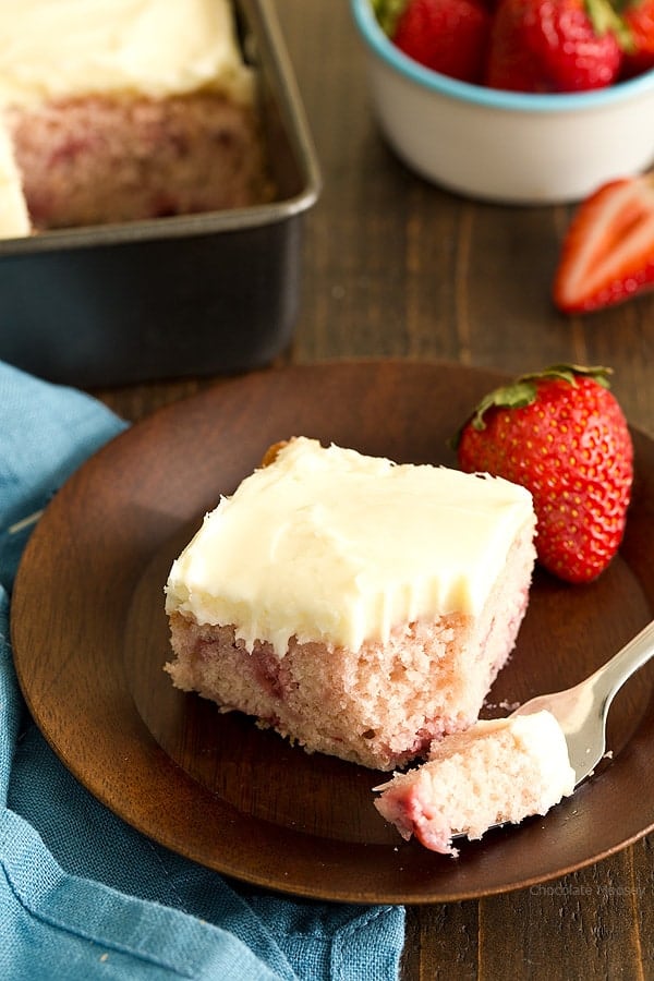This fresh Strawberry Snack Cake is an 8×8 cake recipe made from scratch with fresh strawberries and not cake mix or Jello. Serve it with a homemade cream cheese frosting on top.