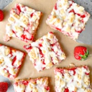 Strawberry Cream Cheese Crumble Bars on a brown paper