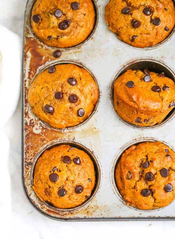 pUMPKIN MUFFINS with chocolate chips in a muffin tin