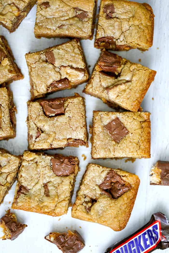 Ultimate Snickers Peanut Butter Blondies are deliciously baked blondies exploding with Snickers and peanut butter flavor!