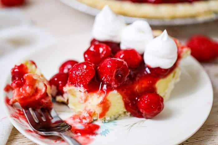 pie with raspberries, whipped cream and pudding