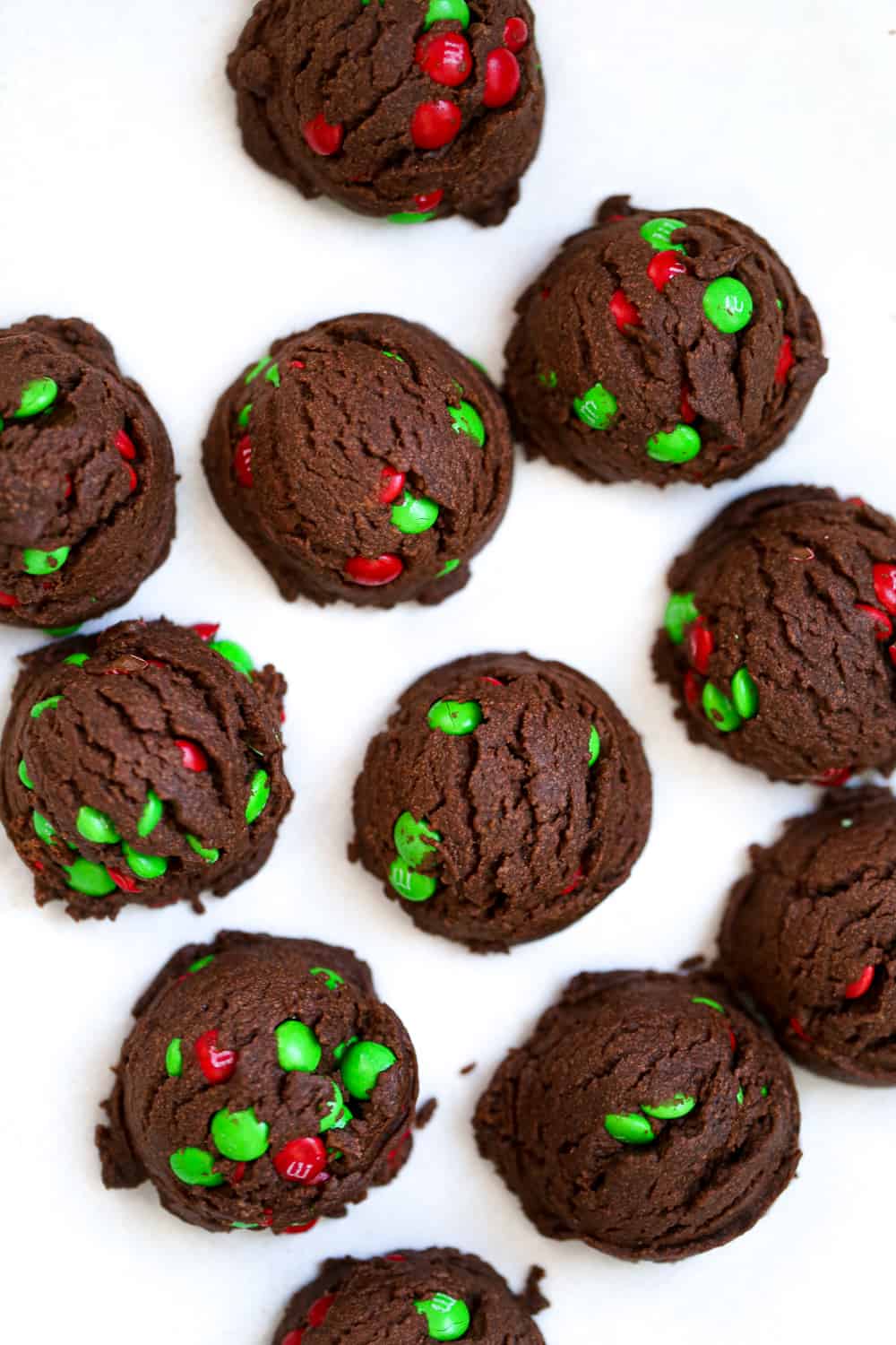 best Chocolate Snowball Cookies recipe with festive m&ms and powdered sugar