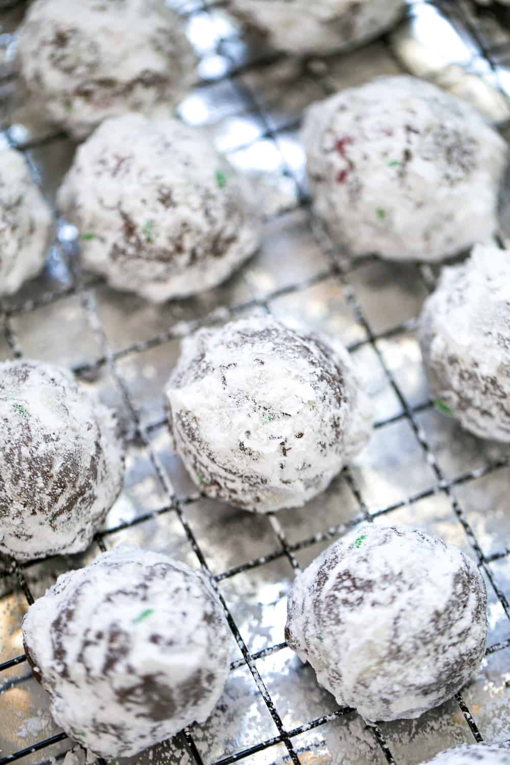 best Chocolate Snowball Cookies recipe with festive m&ms and powdered sugar