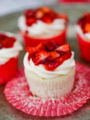 Strawberry Shortcake Cupcakes are vanilla cakes filled with light and fluffy whipped cream and finished with cream cheese frosting and fruity strawberry filling on top. 