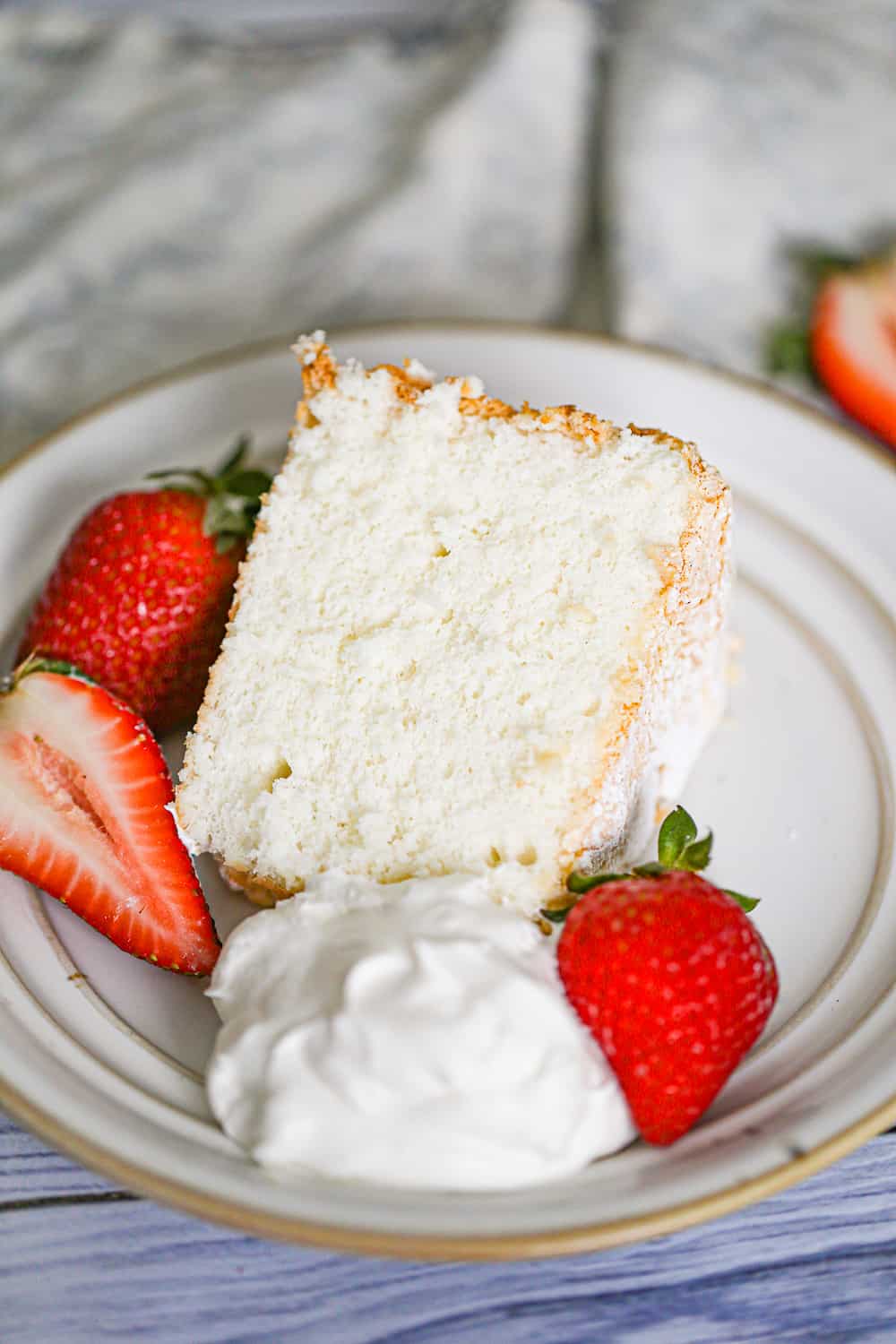 slice of angel food cake with whipped cream and strawberries