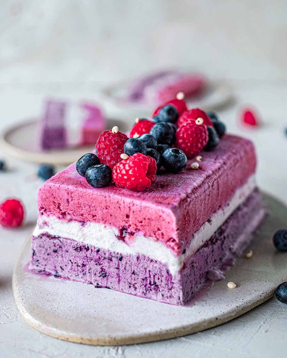 Easy vegan berry ice cream cake recipe with a hint of 'cheesecake' made with only 4-5 ingredients! The vibrant colors makes it a perfect centerpiece for celebrations.