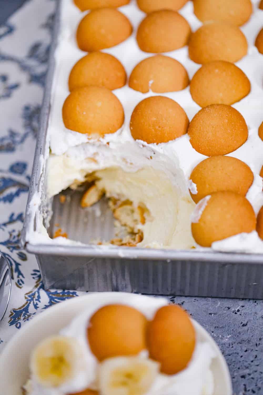 banana pudding in a pan with a scoop out of it
