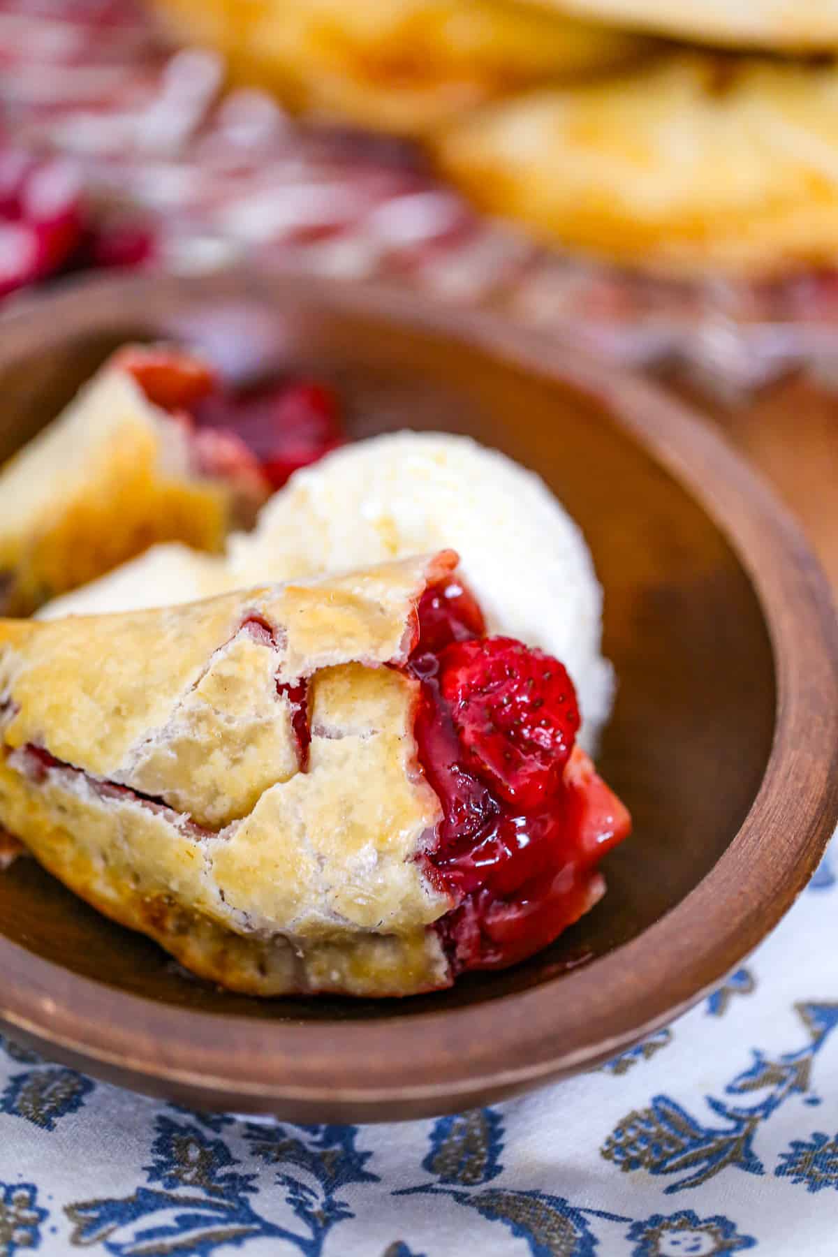 easy hand held pies recipe with shortcuts apple, blueberry, cherry, peach, blueberry, raspberry fillings using pie crust and topped with glaze