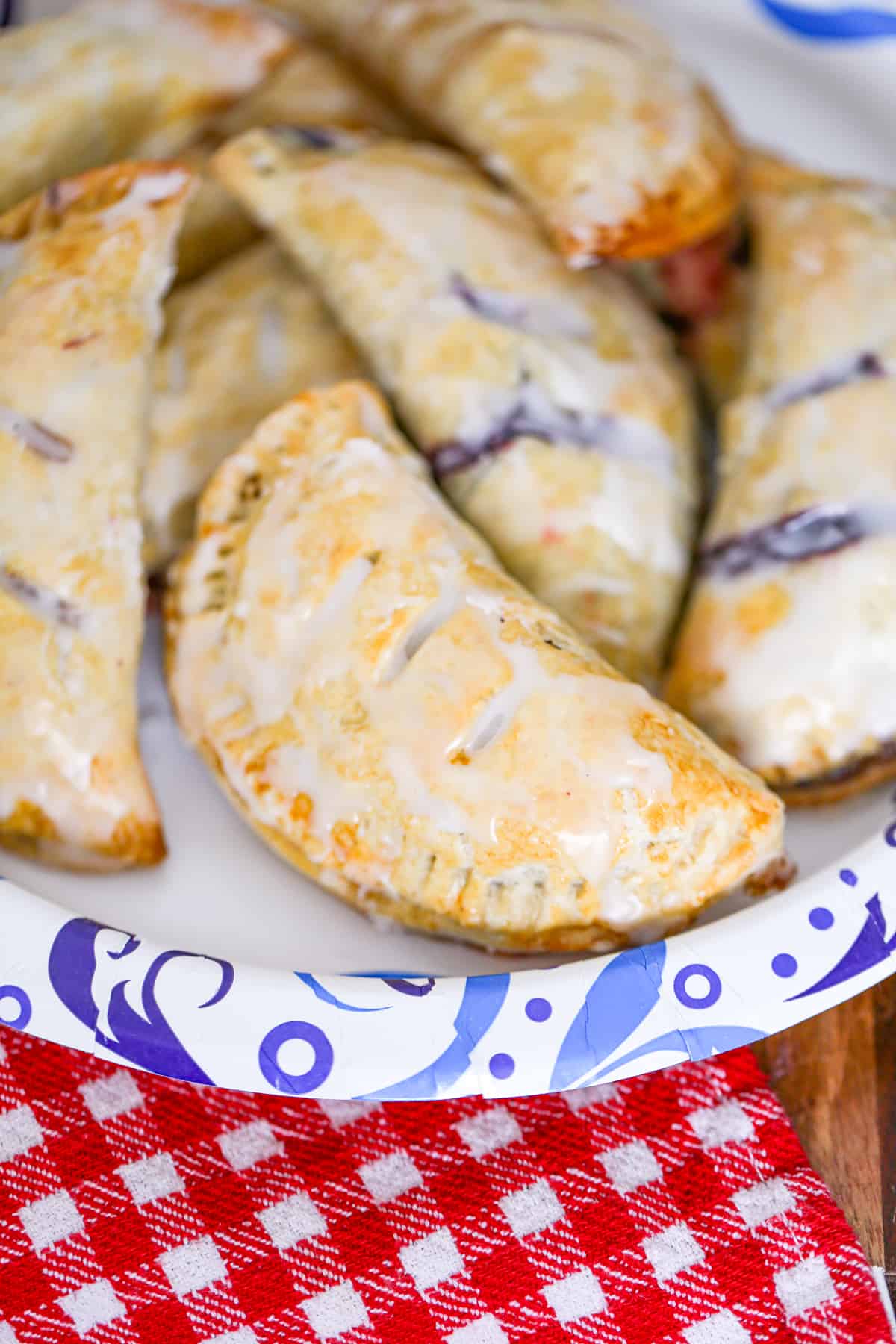 easy hand held pies recipe with shortcuts apple, blueberry, cherry, peach, blueberry, raspberry fillings using pie crust and topped with glaze