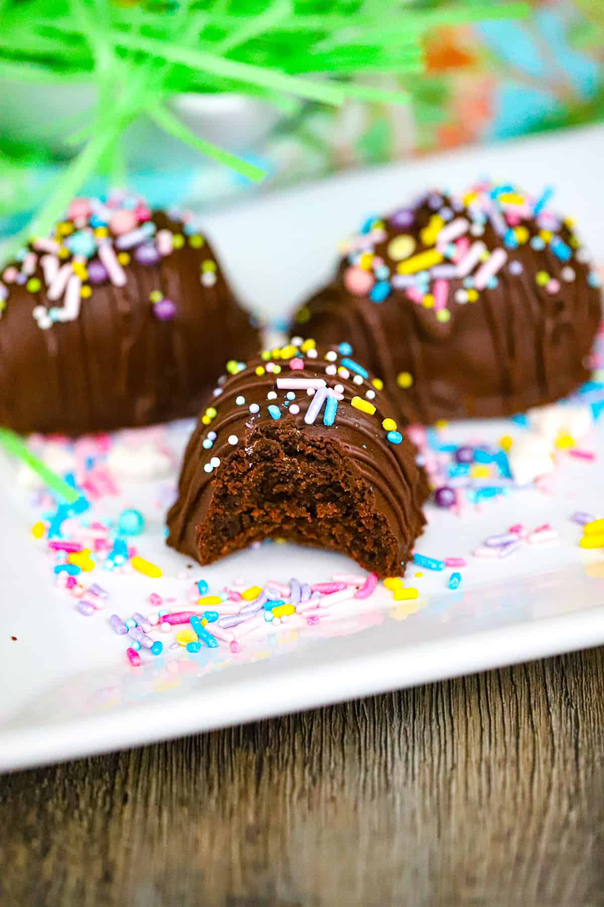 Chocolate truffle mixture shaped into small eggs on parchment paper