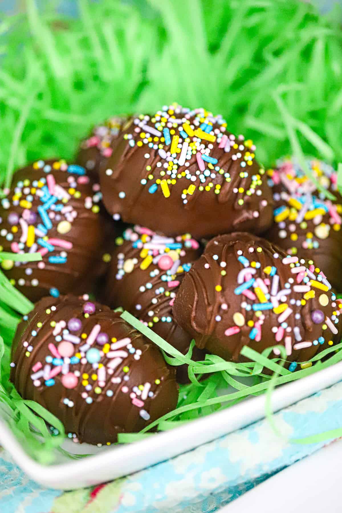Decorated chocolate eggs with pastel sprinkles on a festive plate