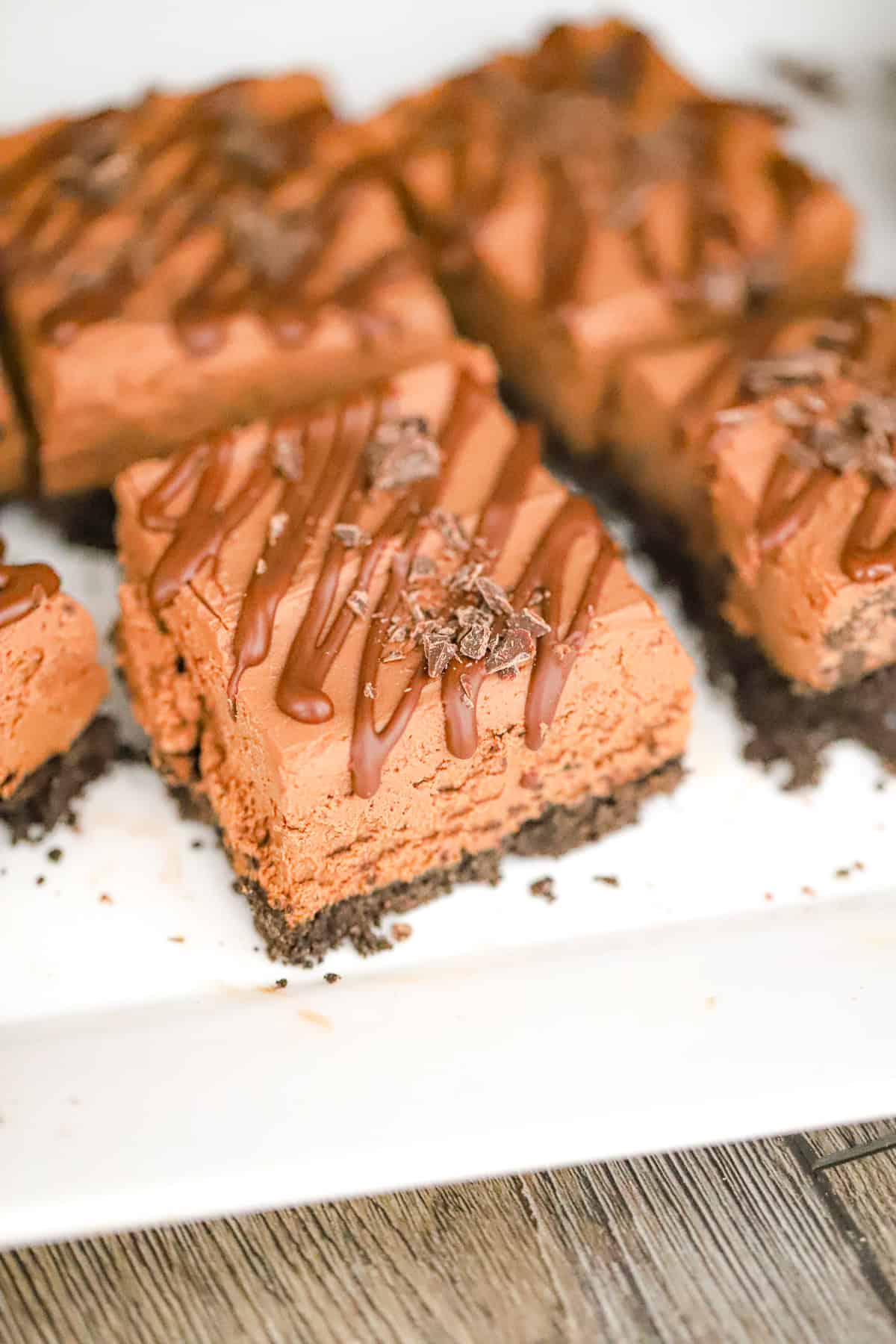 No-bake chocolate fudge protein cheesecake with chocolate drizzle on top