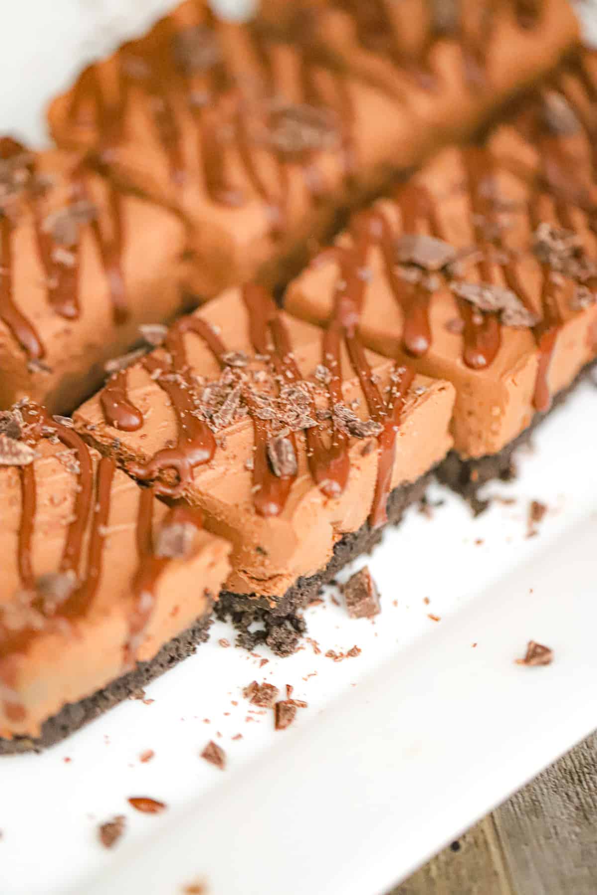 Sliced no-bake dessert bars showing rich fudgy filling layers