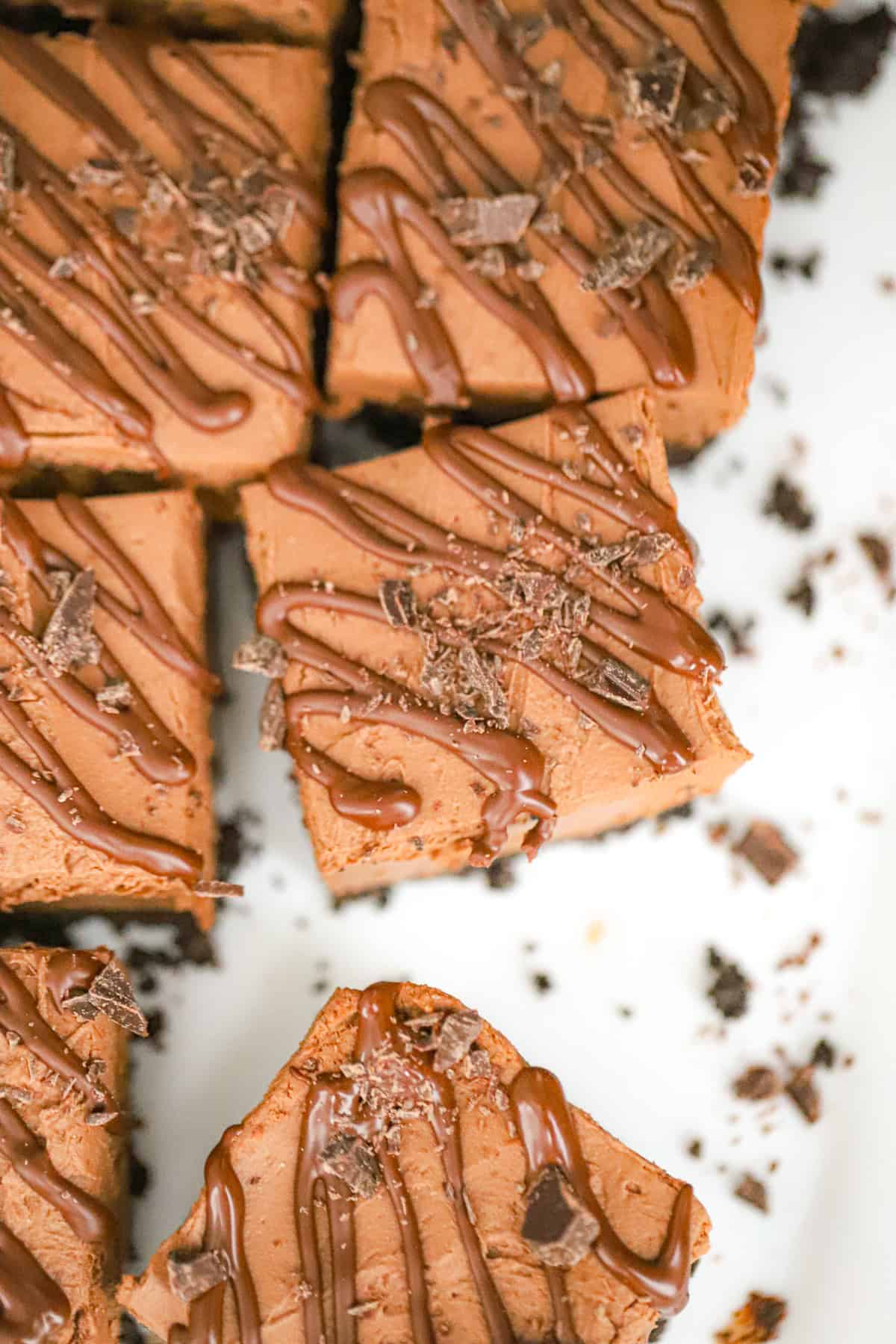 Stacked chocolate bars with cookie crust on parchment paper