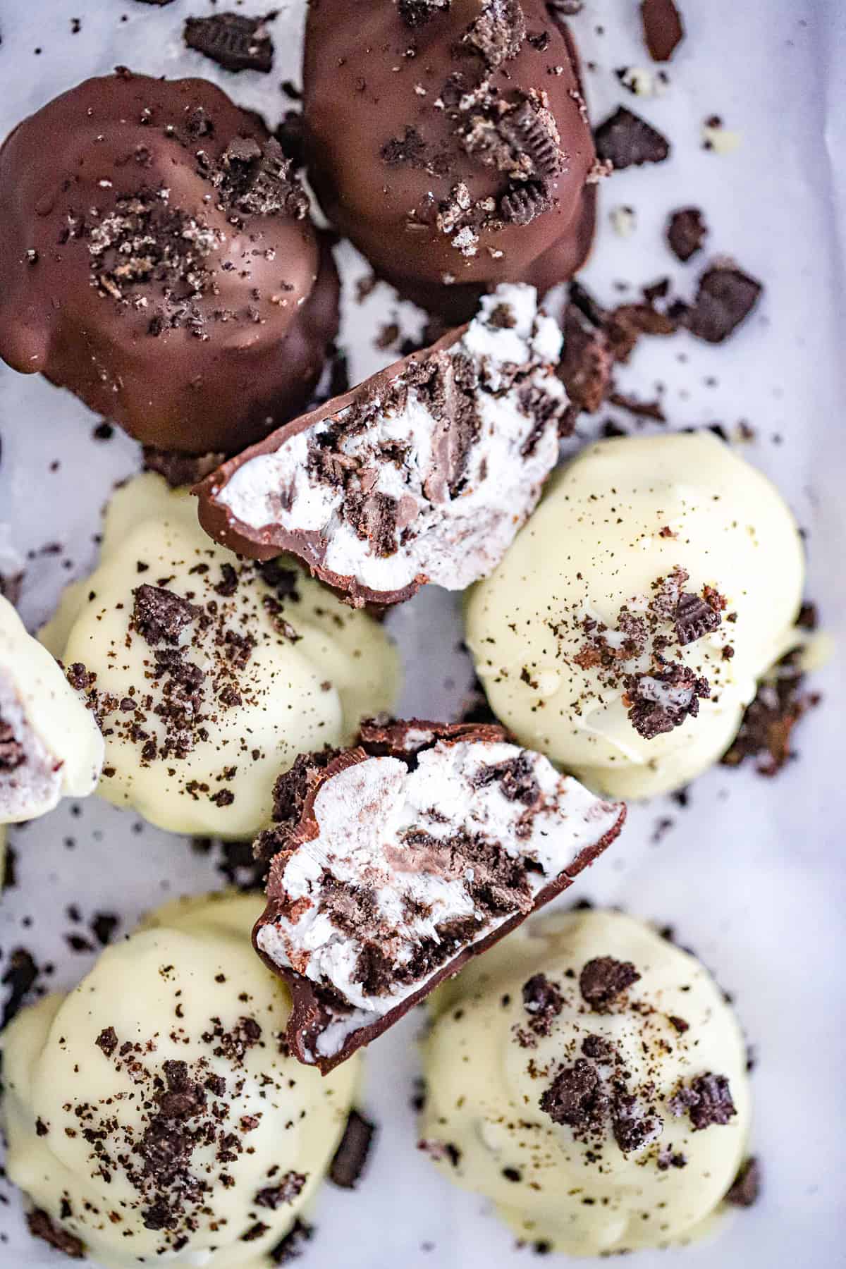 Frozen Oreo yogurt bites dipped in white chocolate with cookie crumbs on top