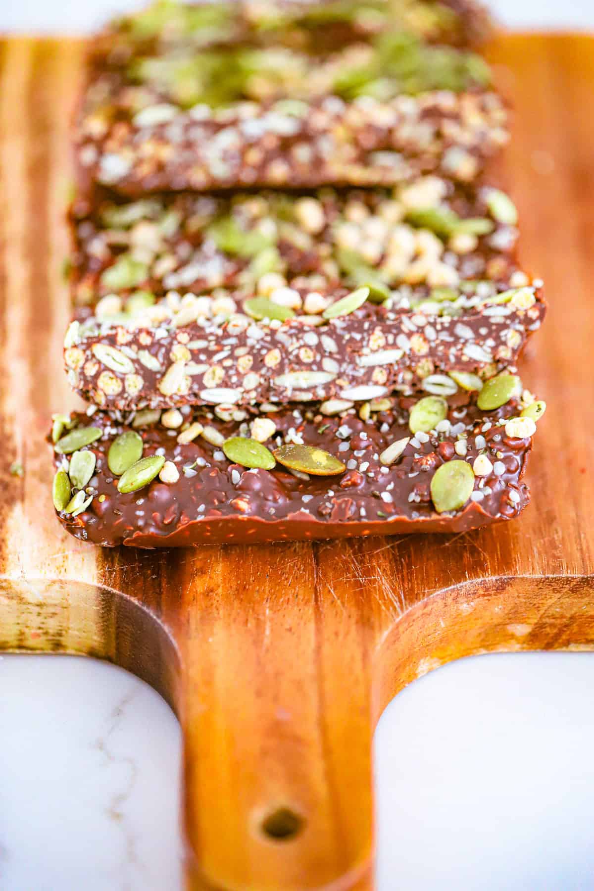 Chocolate seed fudge bars sliced on parchment paper