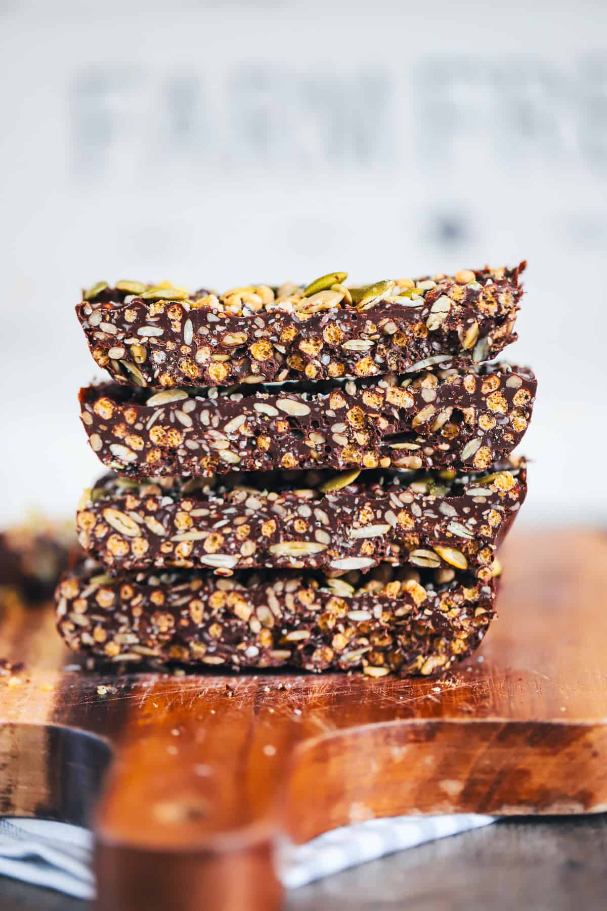Close up of thick fudgy seed bar showing seeds and chocolate layers