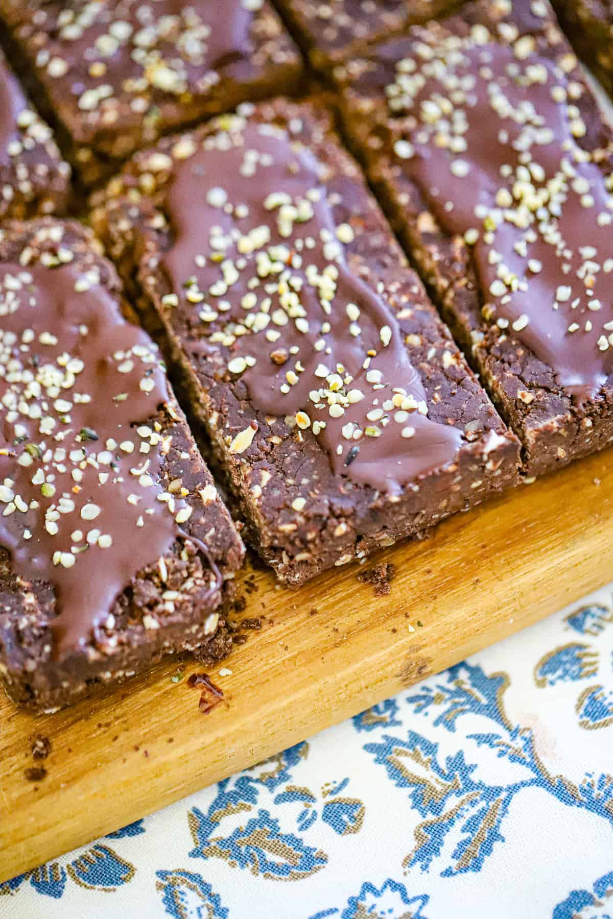 No bake chocolate hemp seed protein bars stacked on parchment paper