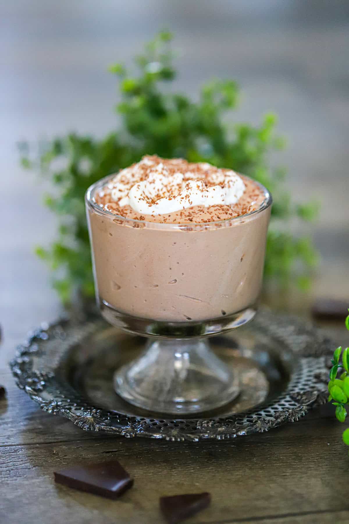 High protein chocolate mousse in glasses topped with berries and shaved chocolate