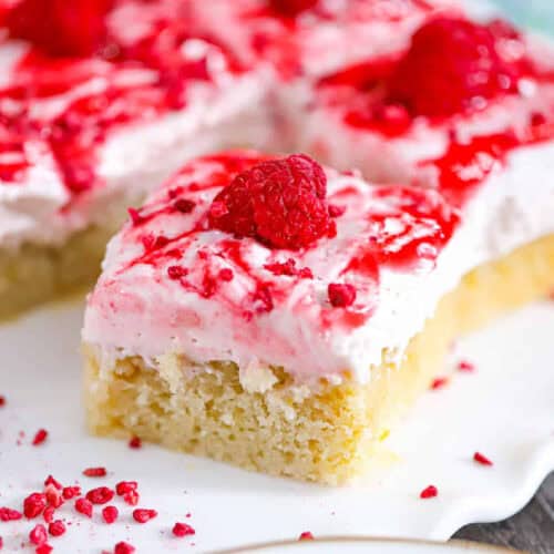 raspberry lemon cream cake bars with fluffy lemon cake and pink raspberry cream layer