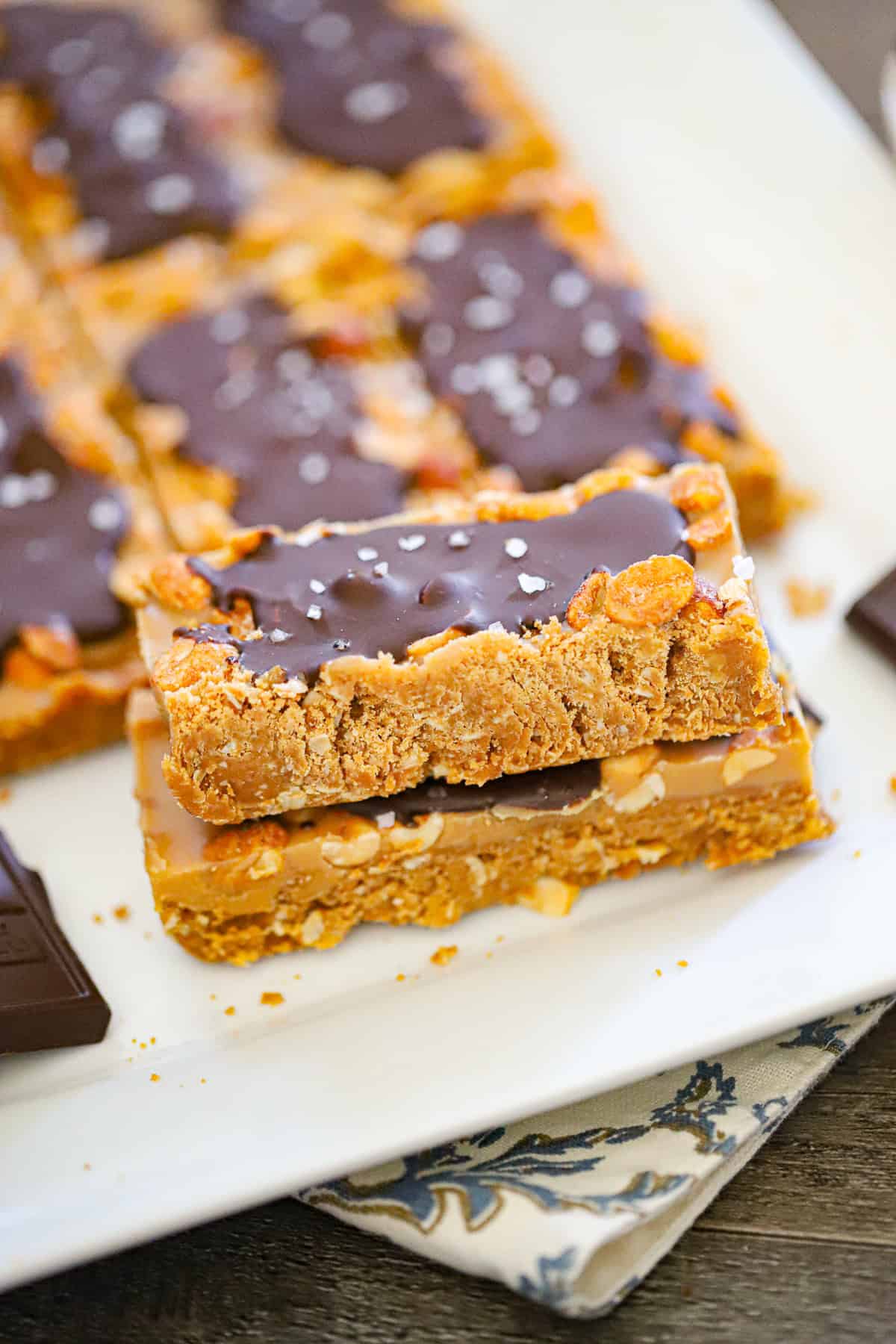 No bake high protein snickers bars with flaky sea salt on chocolate shell