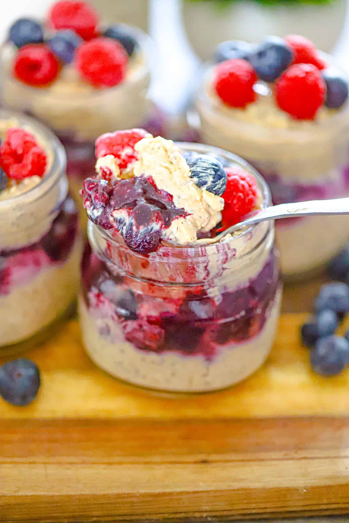 Layered parfait jar of creamy oats with fresh berry topping