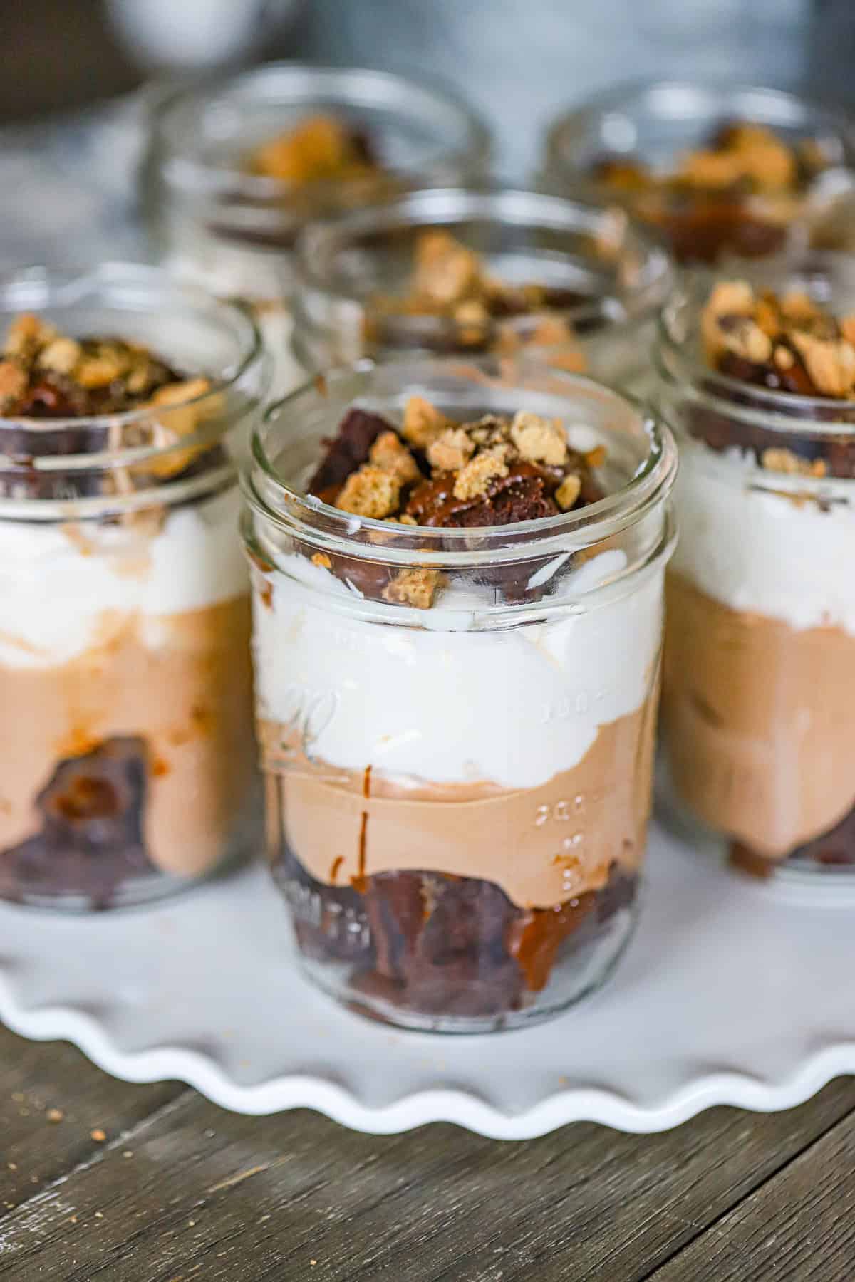 Easy no bake brownie parfaits topped with chocolate frosting and mini chocolate chips