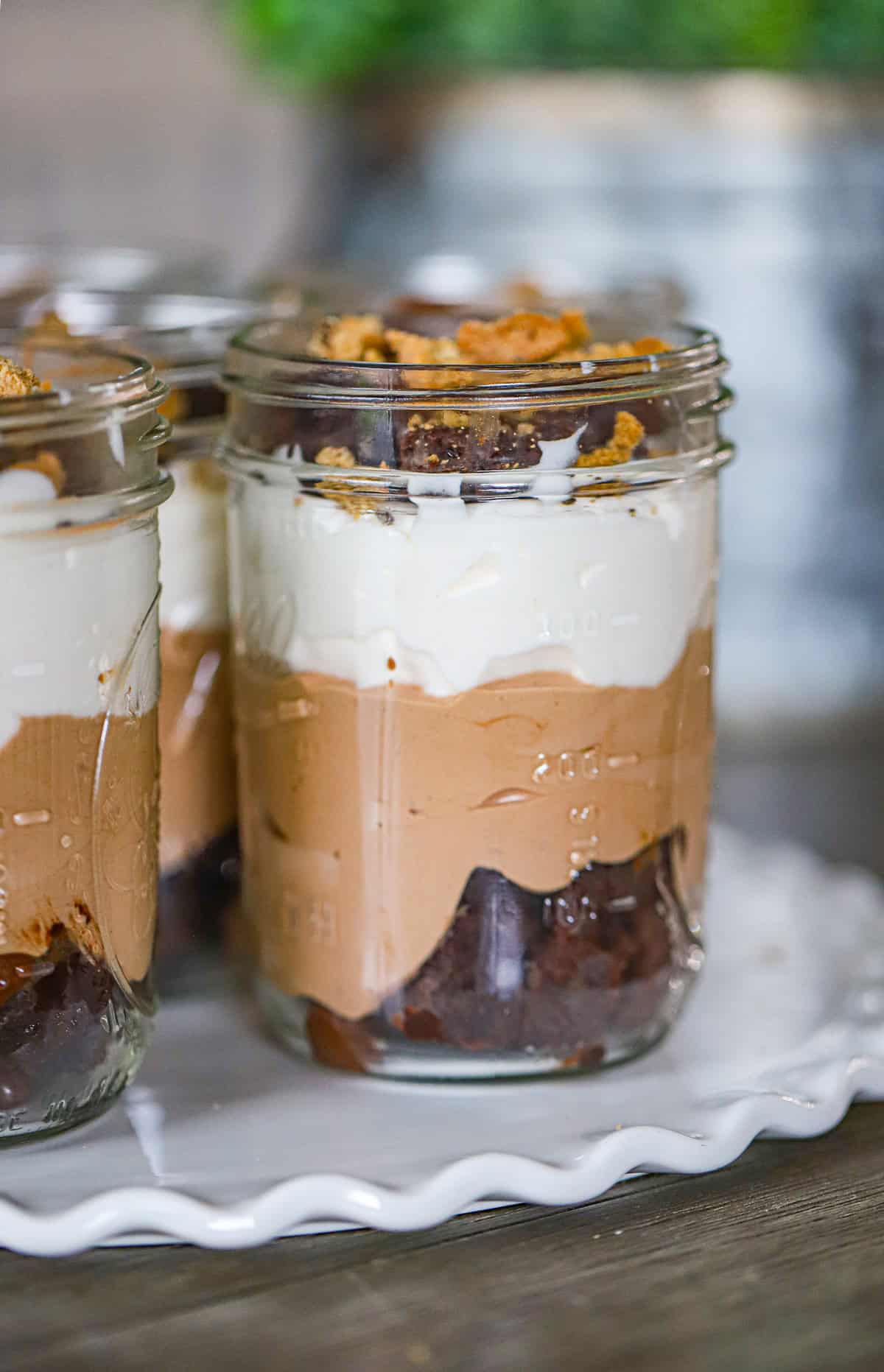 Tall glass of chocolate mousse trifle with brownie chunks and whipped topping