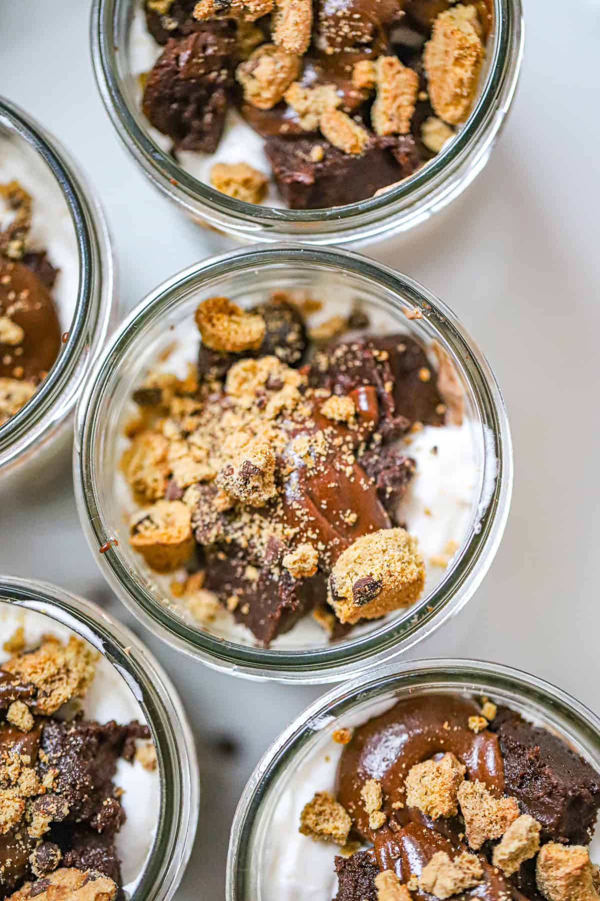 Decadent layered chocolate dessert cup with whipped cream and chocolate shavings