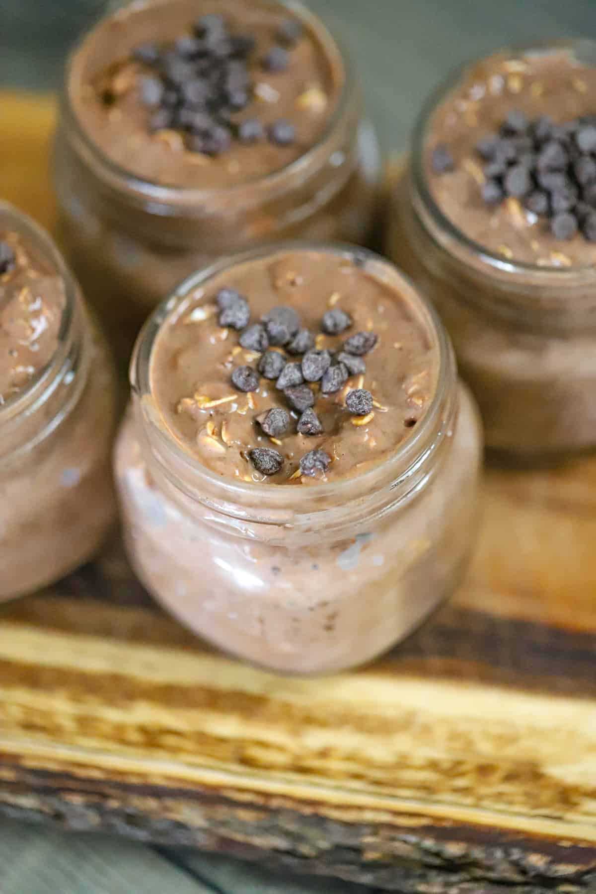 Cocoa powder, oats, chia seeds, and protein powder in a mixing bowl