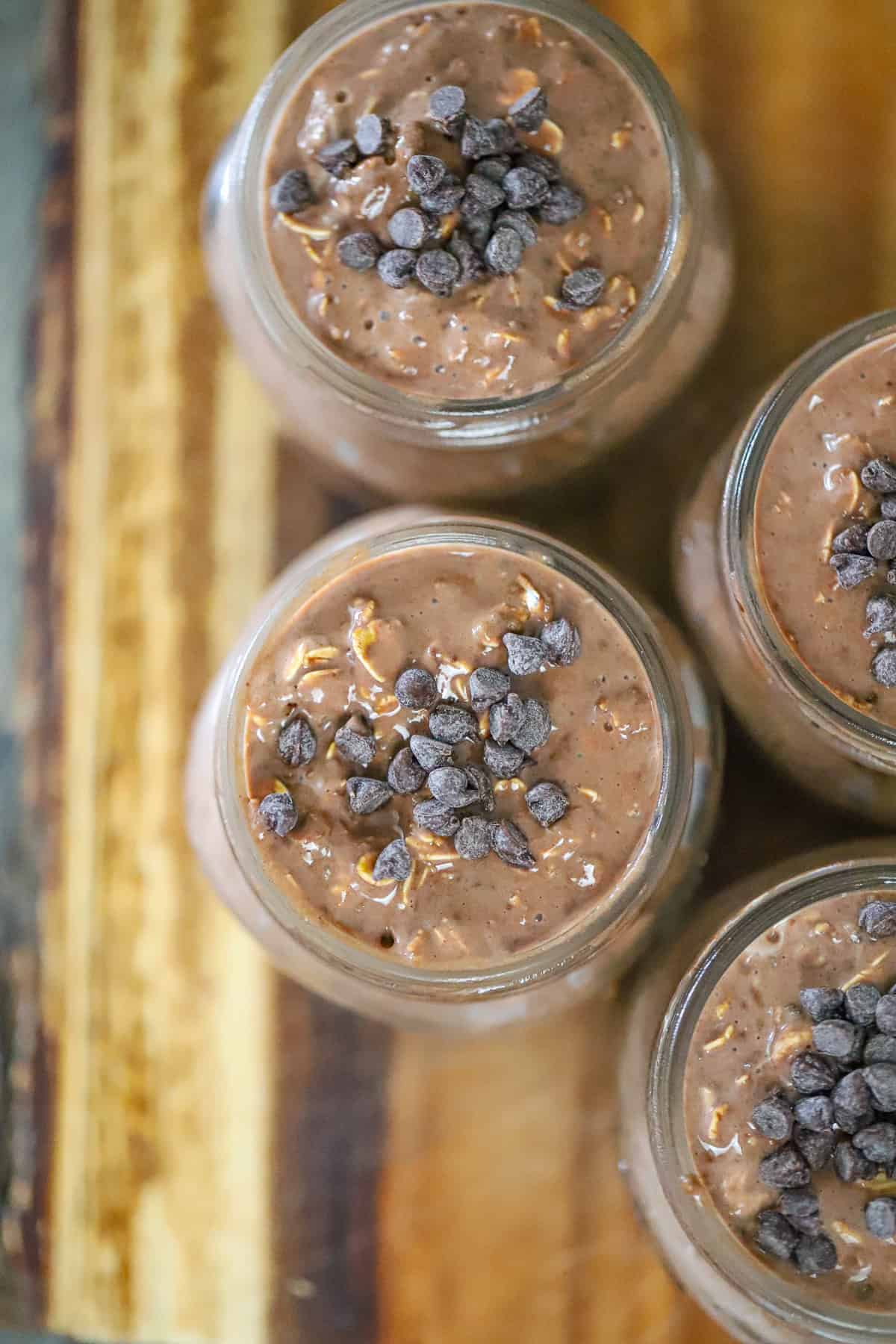 Thick fudgy brownie overnight oats topped with cacao nibs and walnuts