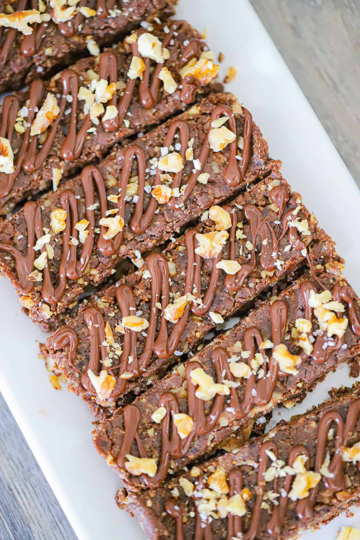 Date brownie protein bars with walnuts and chocolate drizzle