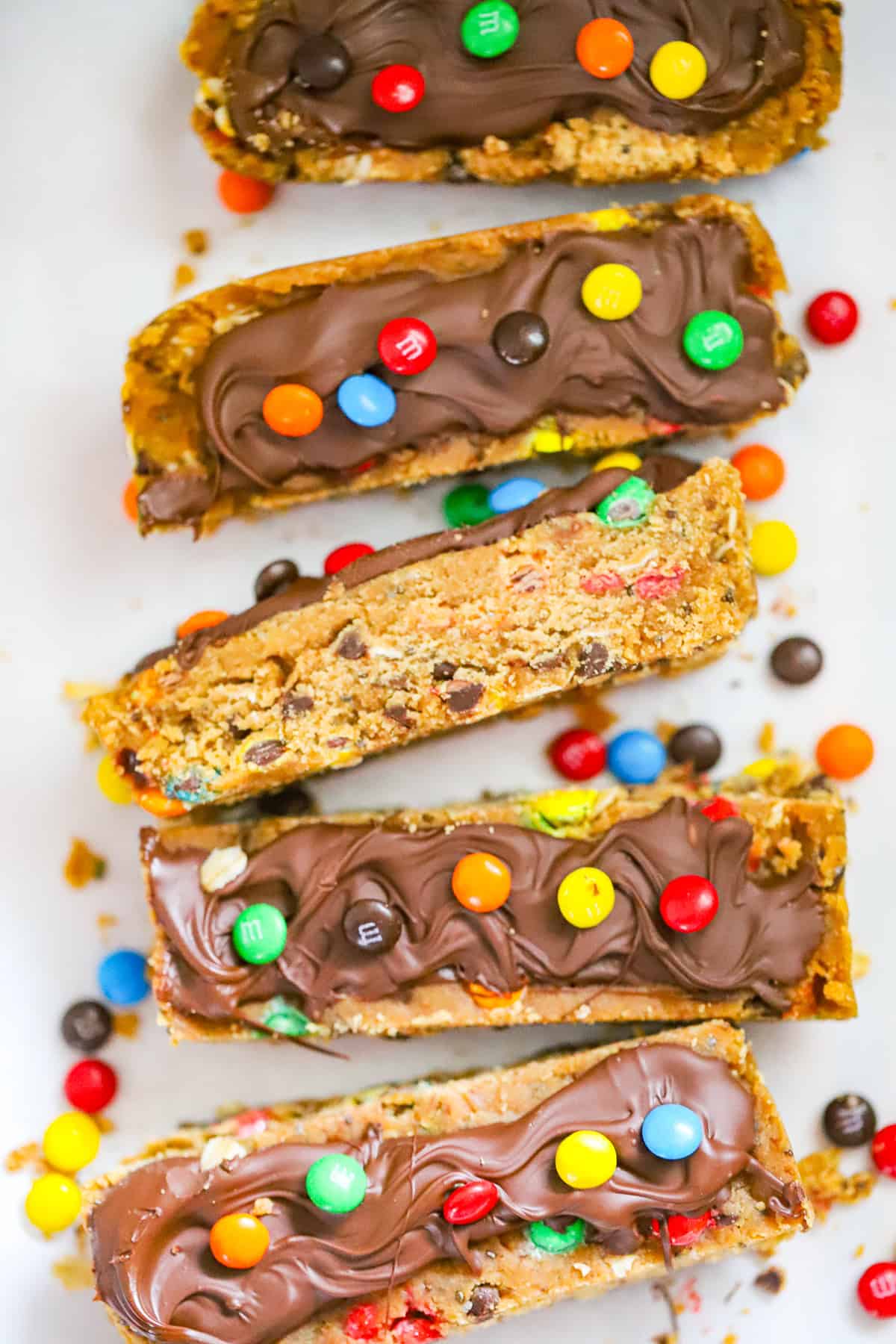 Thick chewy no bake bars with peanut butter chocolate chips and colorful M&Ms