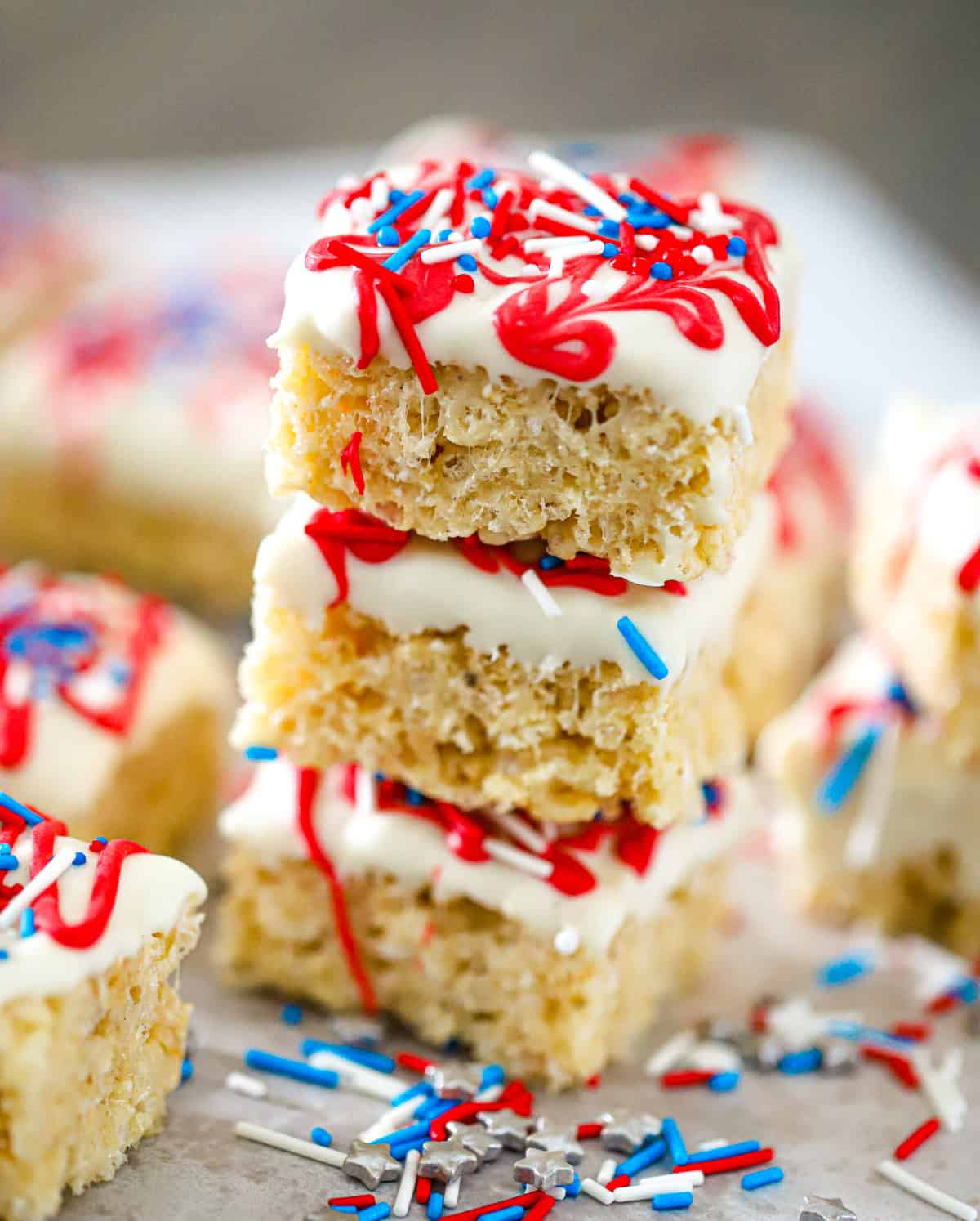 Red white blue krispie bites stacked with patriotic sprinkles on top