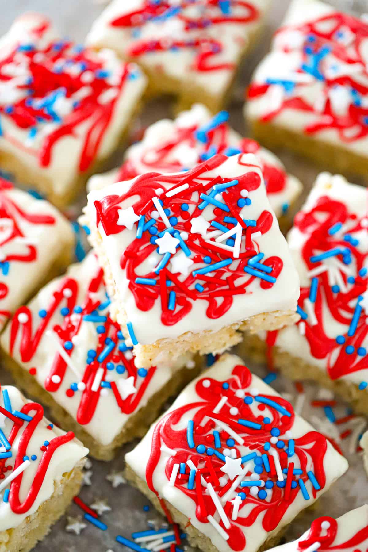 Festive red white blue krispie bites with red and blue sprinkles for 4th of July patriotic krispie treats