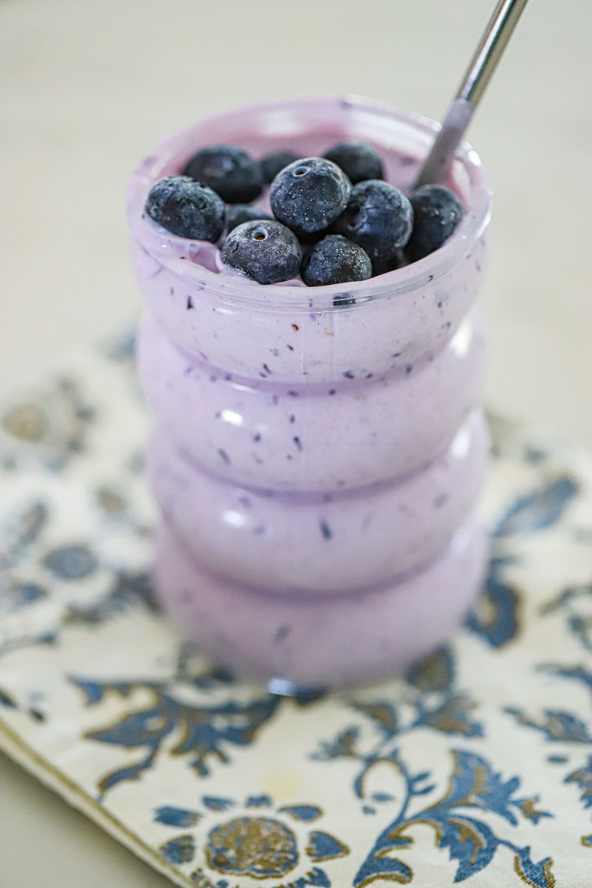 purple smoothie poured into a clear glass
