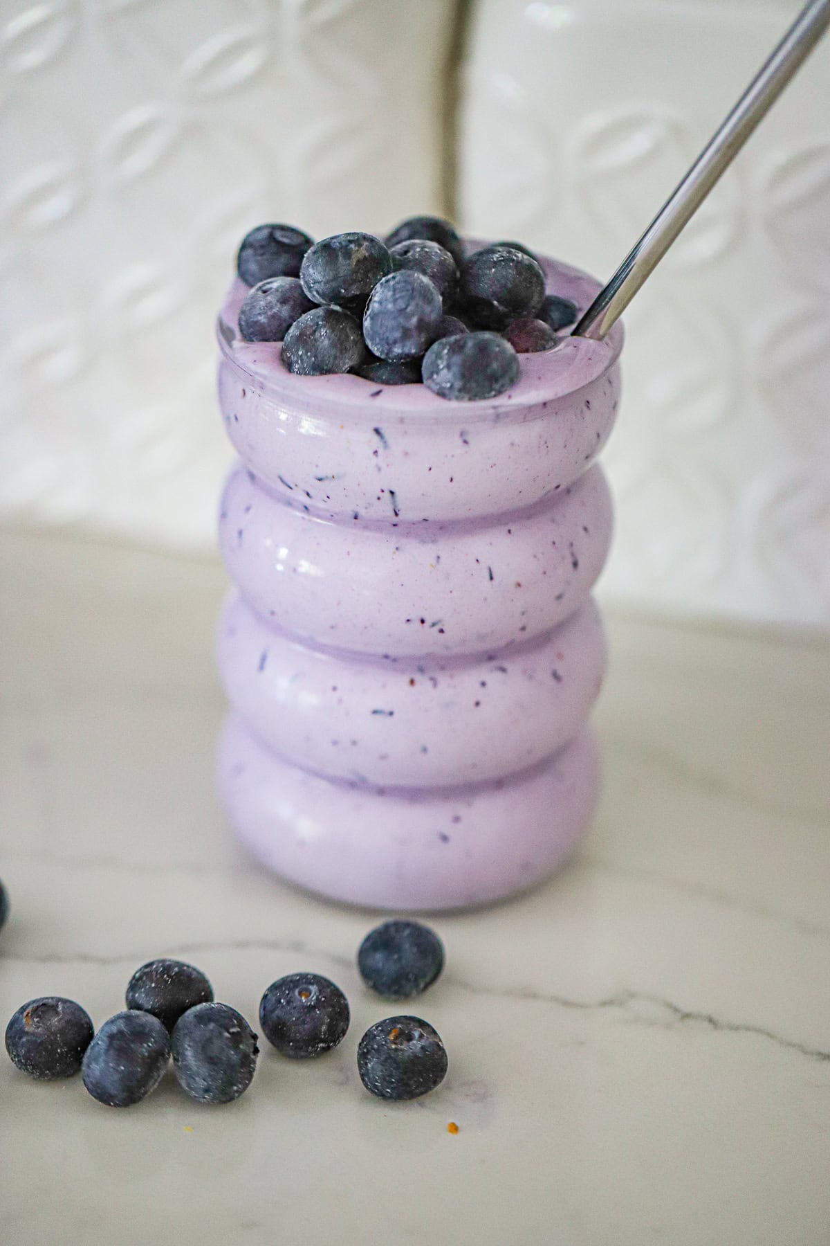 frosty smoothie topped with fresh blueberries