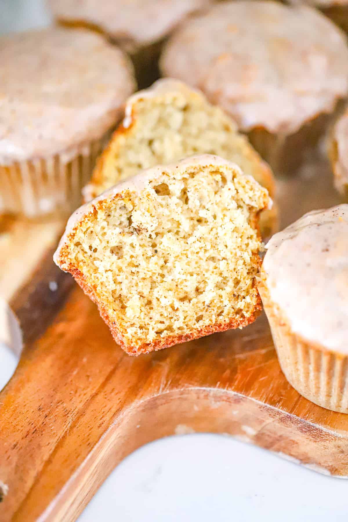 bakery style muffin split open showing the tender, fluffy crumb