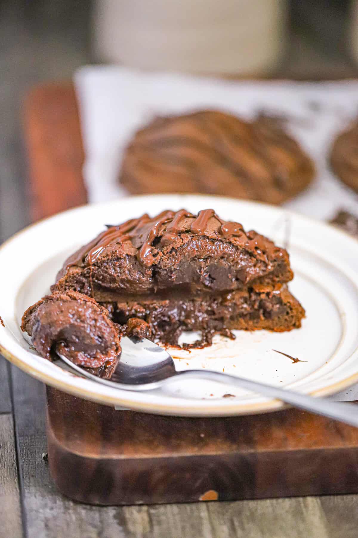 thick chocolate cookie broken open with an oozing fudge center