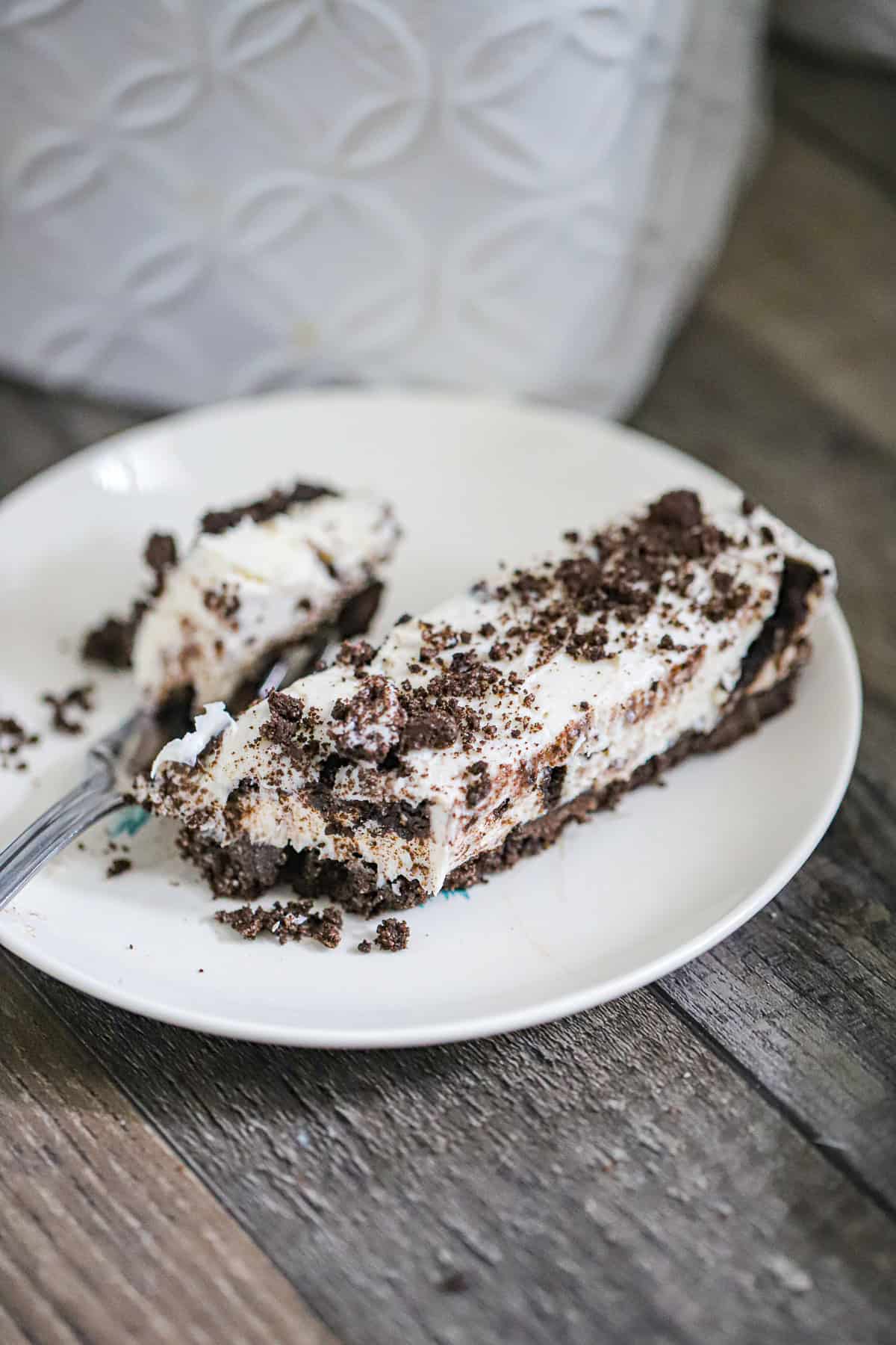 Sliced no-bake cheesecake bars showing creamy Oreo filling layers
