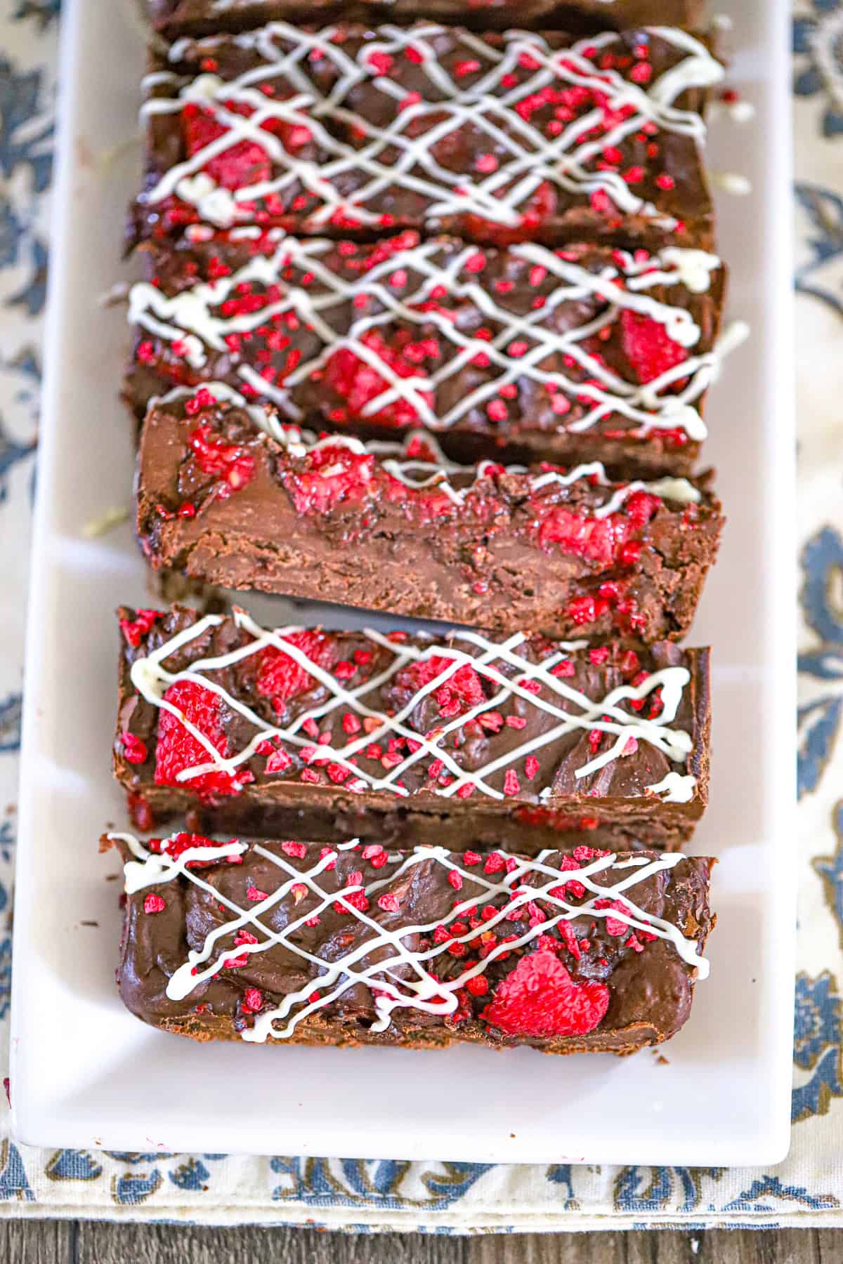 Glossy chocolate fudge studded with fresh raspberries in a loaf pan