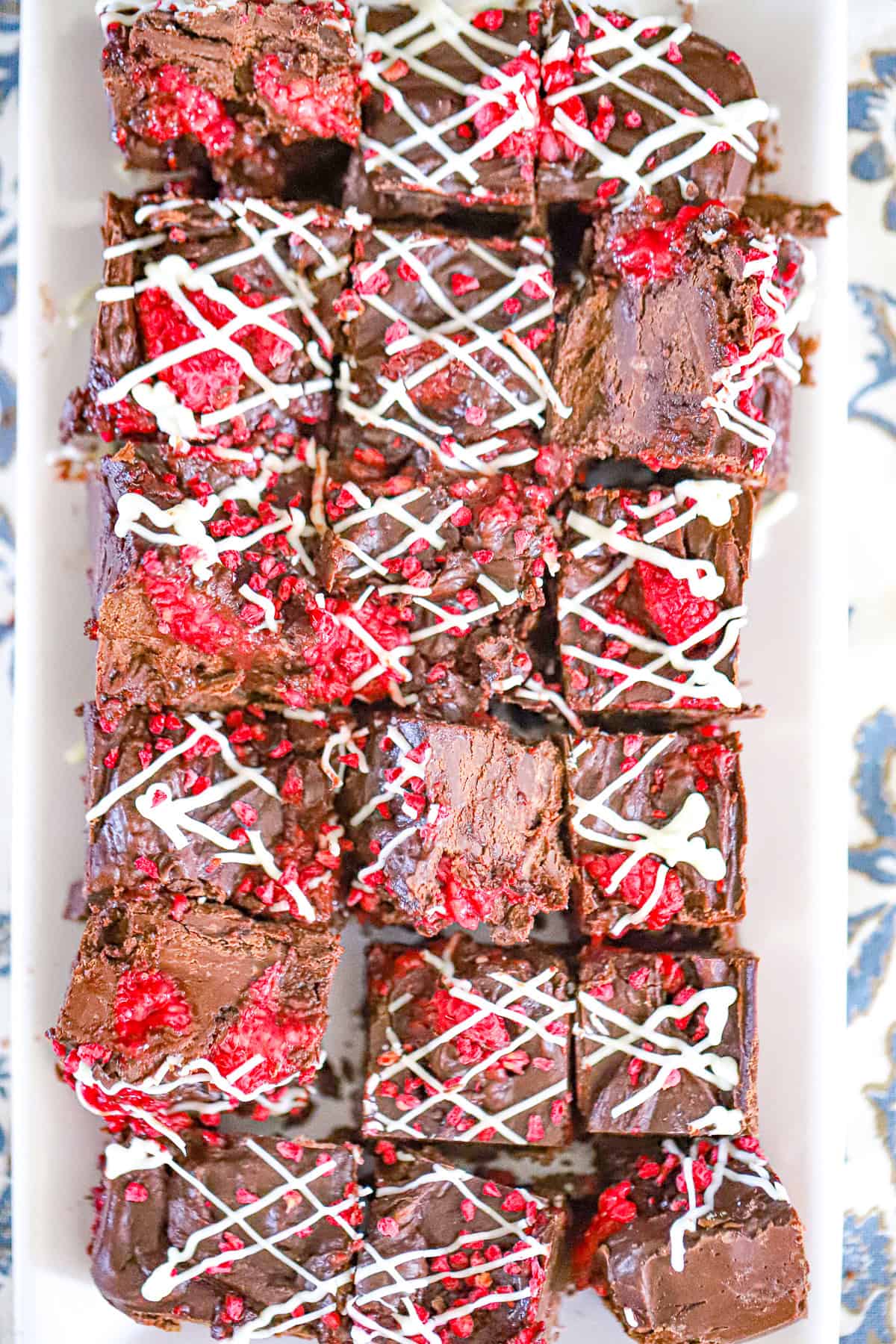Close up of raspberry chocolate fudge topped with fresh raspberries