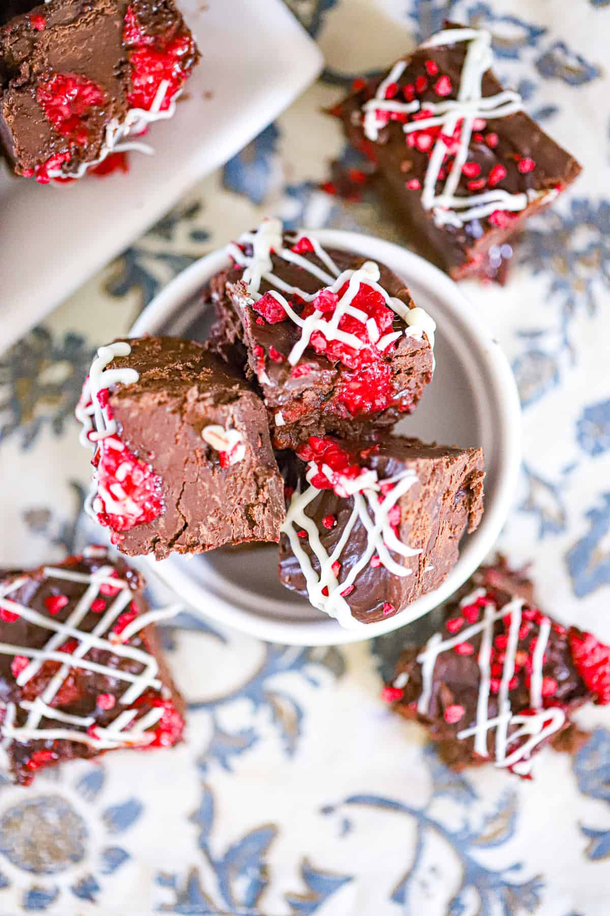 Easy raspberry fudge bars drizzled with white chocolate