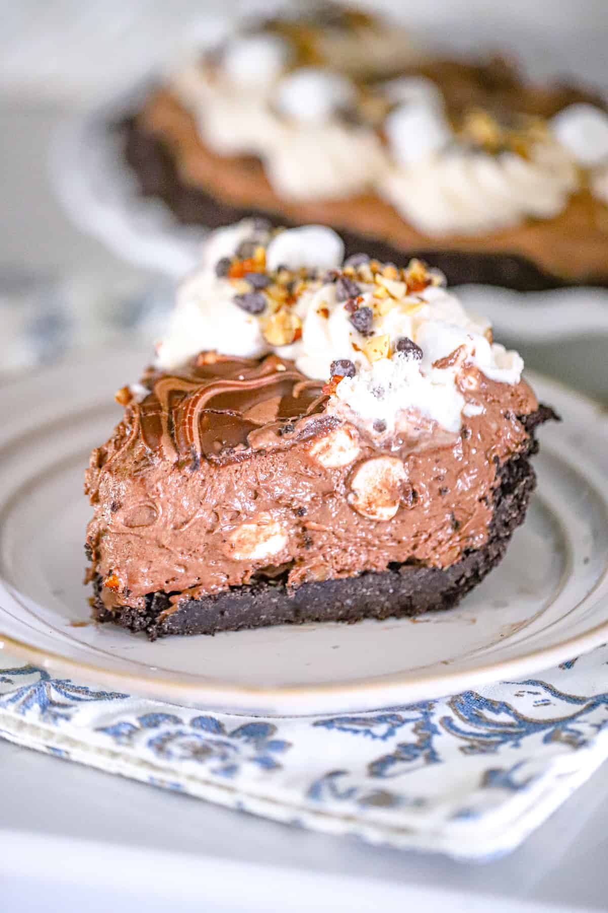 No bake rocky road pie sliced tall showing whipped chocolate filling and marshmallow topping