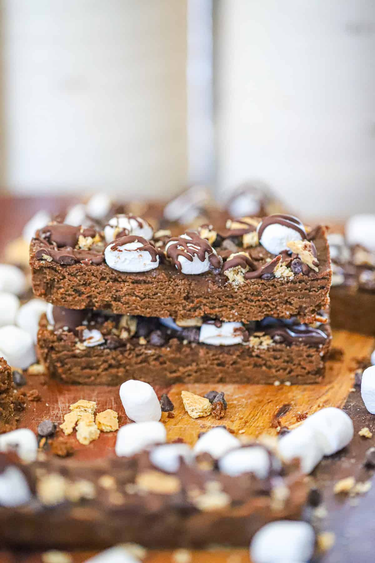 Chocolate drizzled protein bars topped with mini marshmallows and graham cracker crumbs