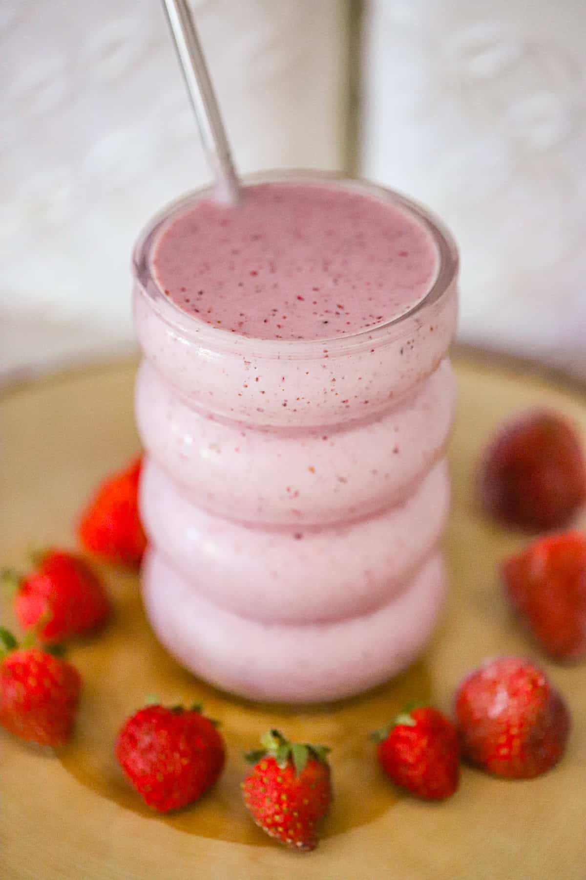 strawberry vanilla yogurt smoothie in a tall glass