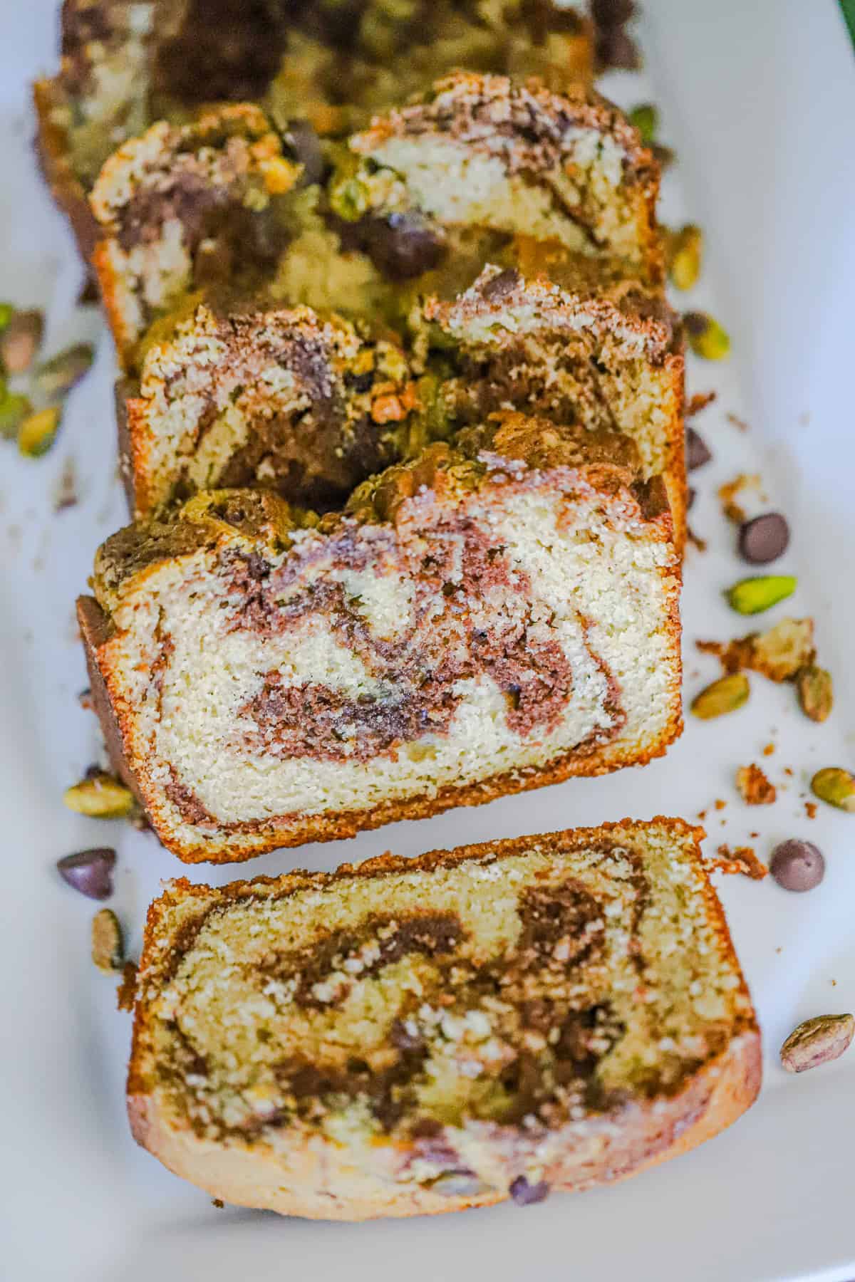 Sliced chocolate pistachio swirl bread showing marbled chocolate and pistachio interior
