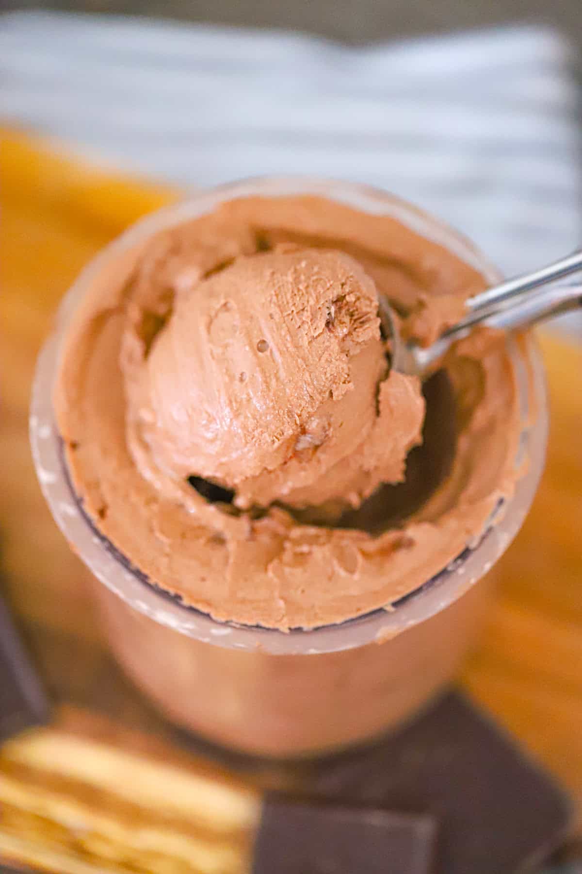 Spoon digging into a creamy chocolate frozen dessert ninja creami greek yogurt recipe