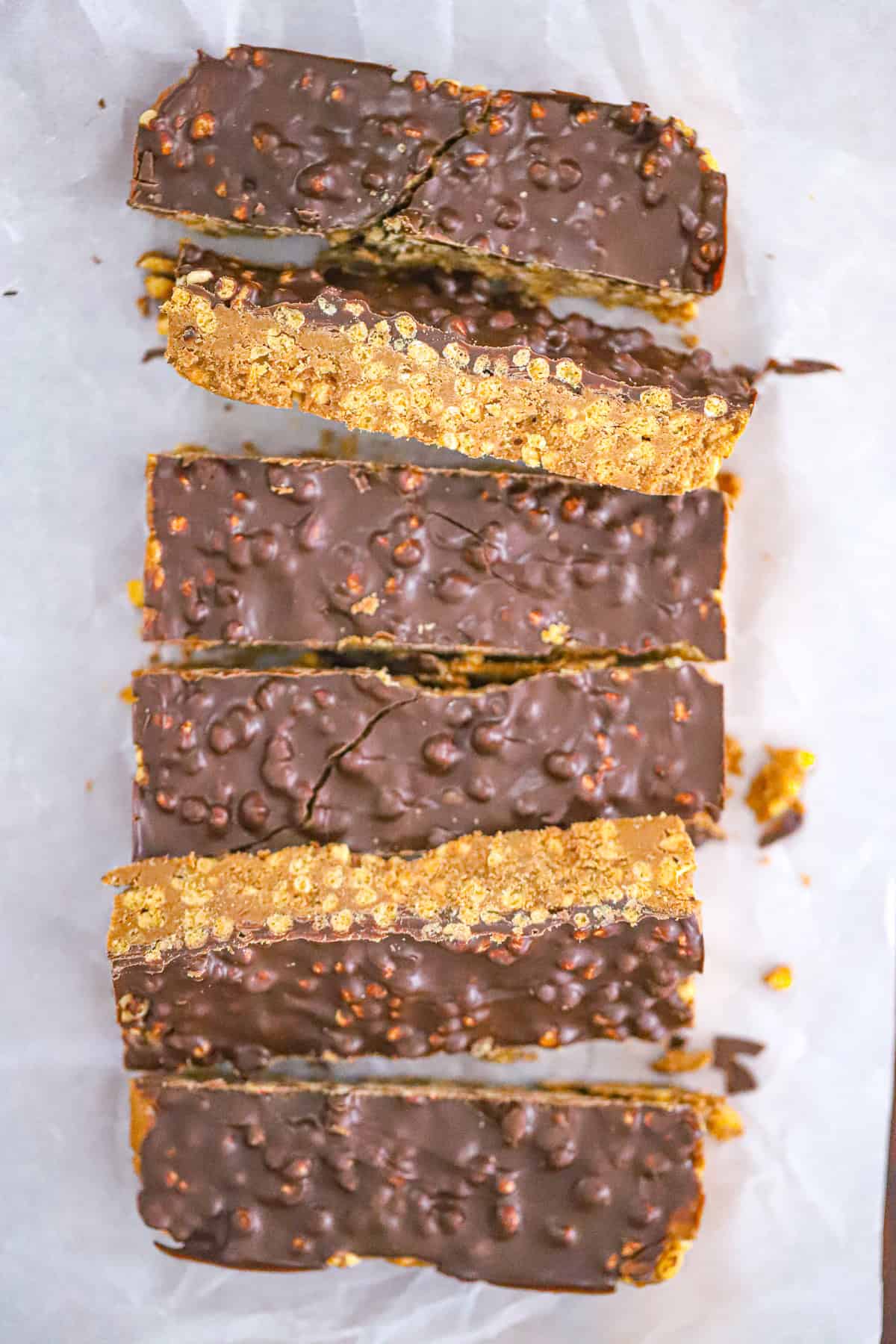 Fudgy no bake peanut butter bars with a glossy melted chocolate layer and flaky sea salt
